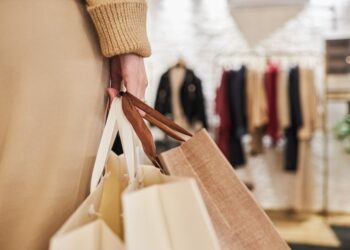 Closeup of unrecognizable young woman carrying bags