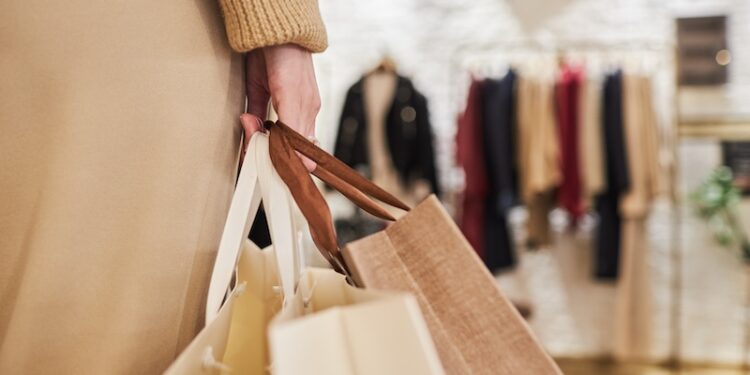 Closeup of unrecognizable young woman carrying bags
