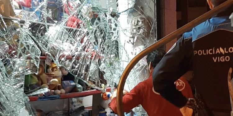 Un conductor se da a la fuga tras estampar un contenedor contra un escaparate: «Casi nos arrolla»